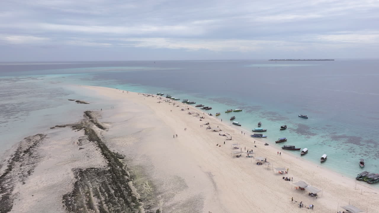 Amazing aerial shot of Nakupenda island, sandbank atoll in the ocean,clear water, white sand, boats, yachts, blue sea during low tide at sunny summer day in Zanzibar.Tanzania