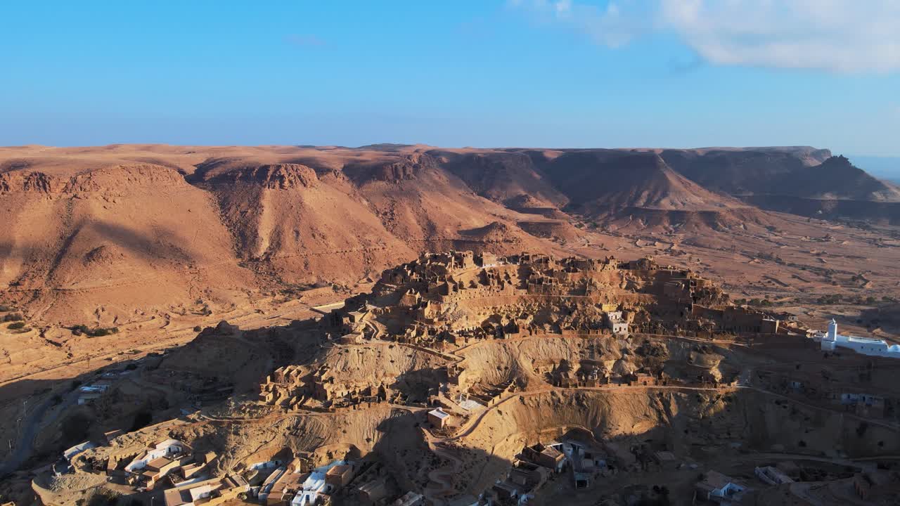 Stunning aerial view of Chennini, a traditional Berber village nestled in the dramatic landscape of southern Tunisia.