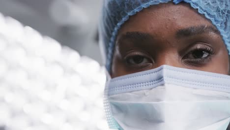 Porträt-Einer-Afroamerikanischen-Ärztin-Mit-Gesichtsmaske-Im-Operationssaal-Des-Krankenhauses,-Zeitlupe