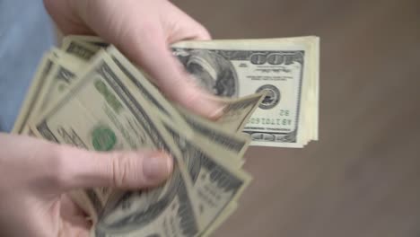 close-up of female hands counting dollars