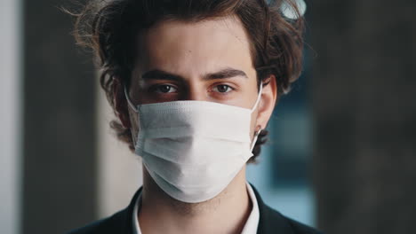 close-up portrait of a young man wearing a face mask