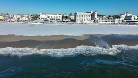 sand ocean beach covered in winter snow