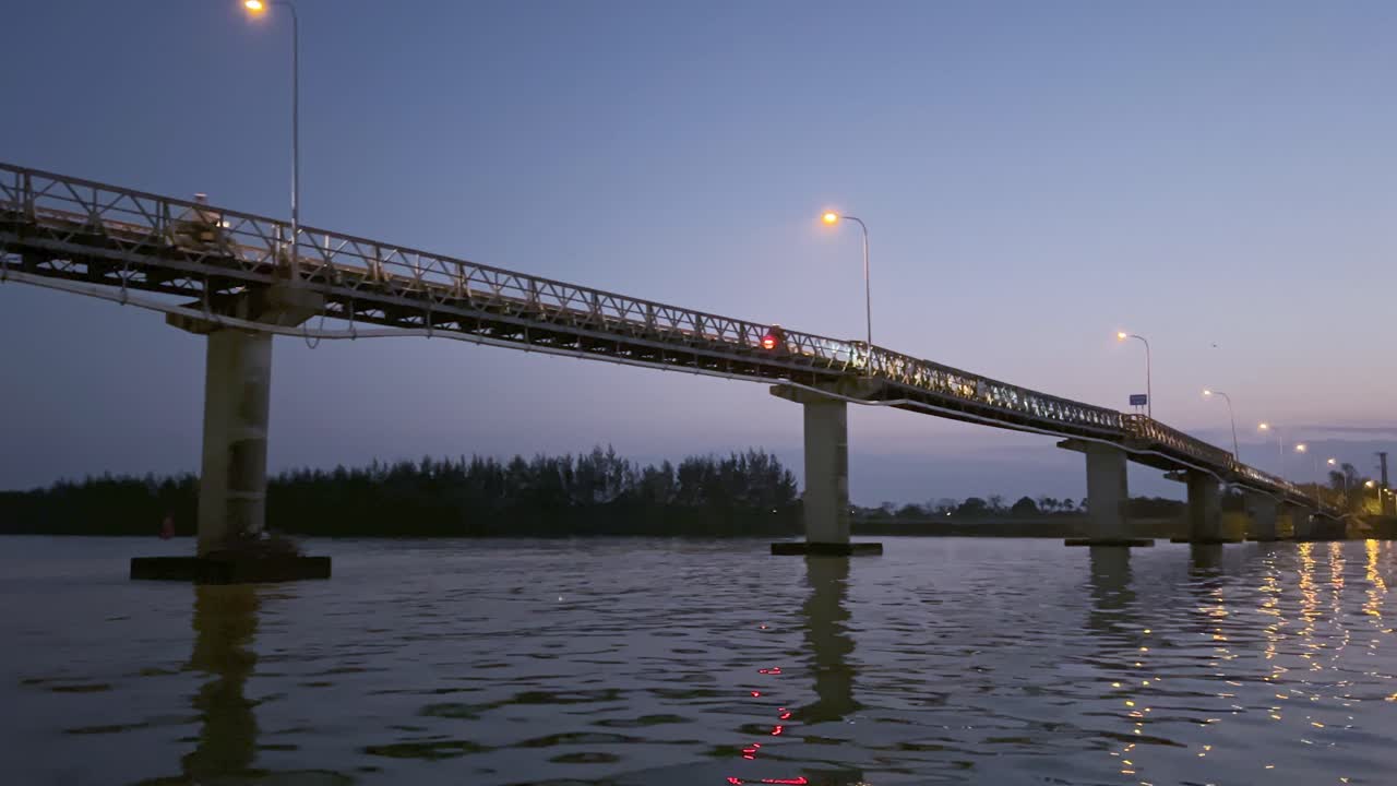 Vehicles Driving On Cam Kim Bridge Across Thu Bon River At Sunset In Hoi An, Vietnam. wide shot