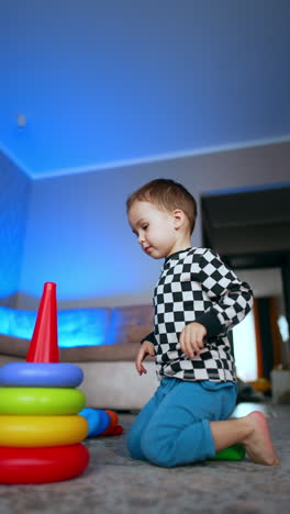 creative childhood playing. small kid playing on a floor with colorful toys. vertical video.