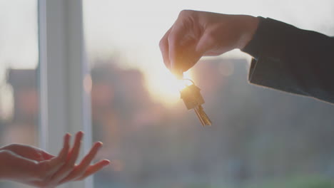 real estate man giving keys to the woman