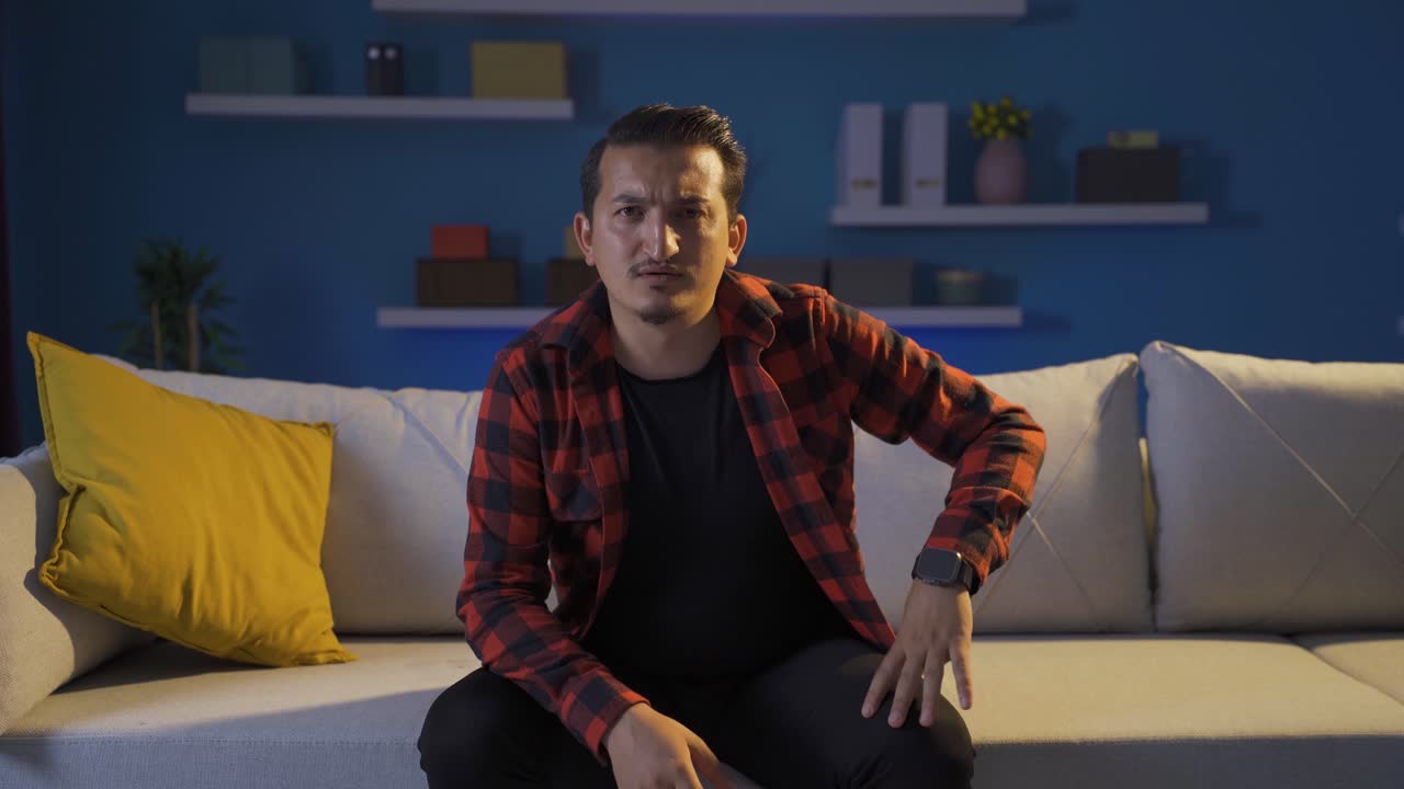 Depressed man talking to camera.