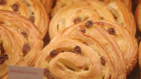 close-up of a display of assorted pastries and bread with raisins