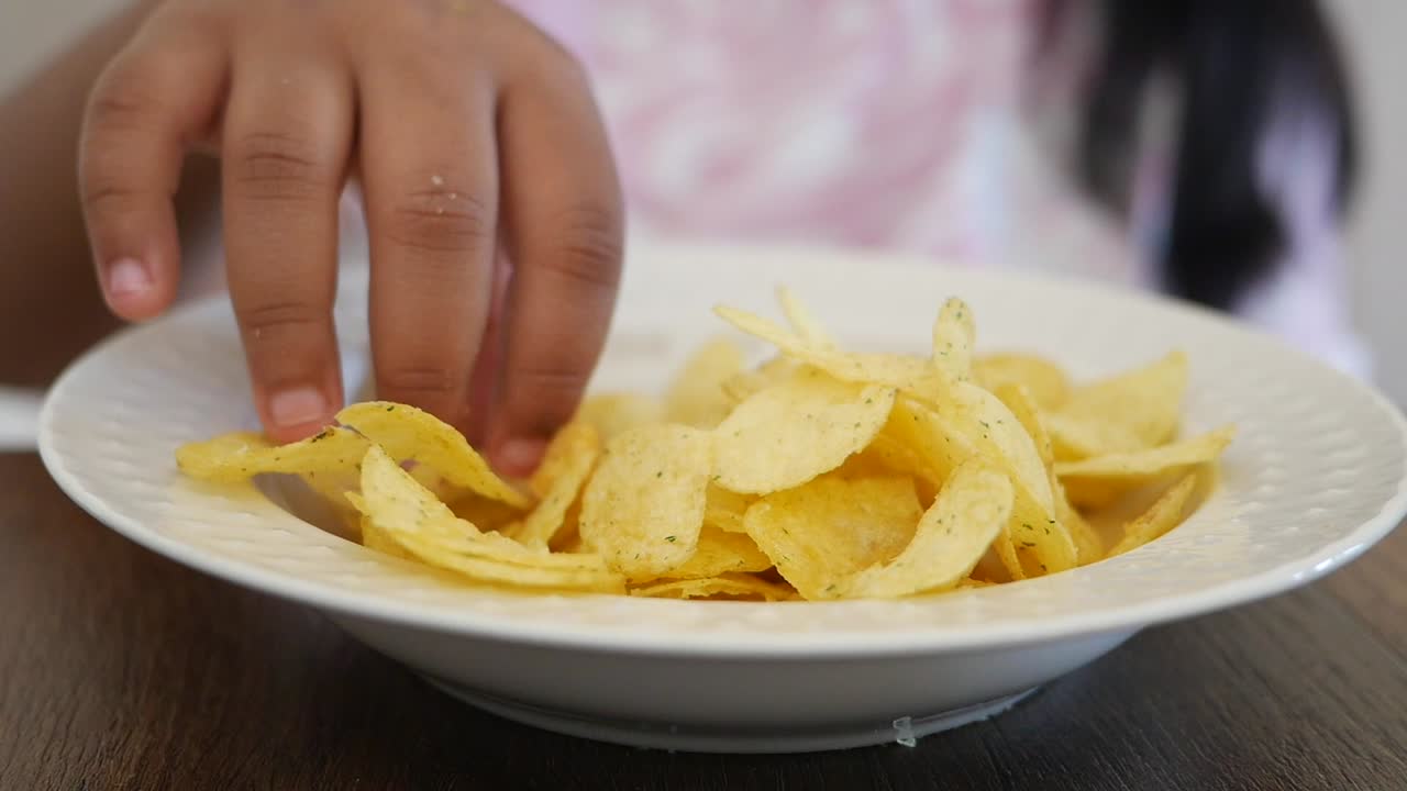 Child eating potato chips
