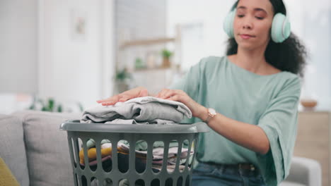 laundry, headphone and woman packing clothes