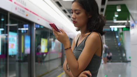 young woman using phone in subway station,4k