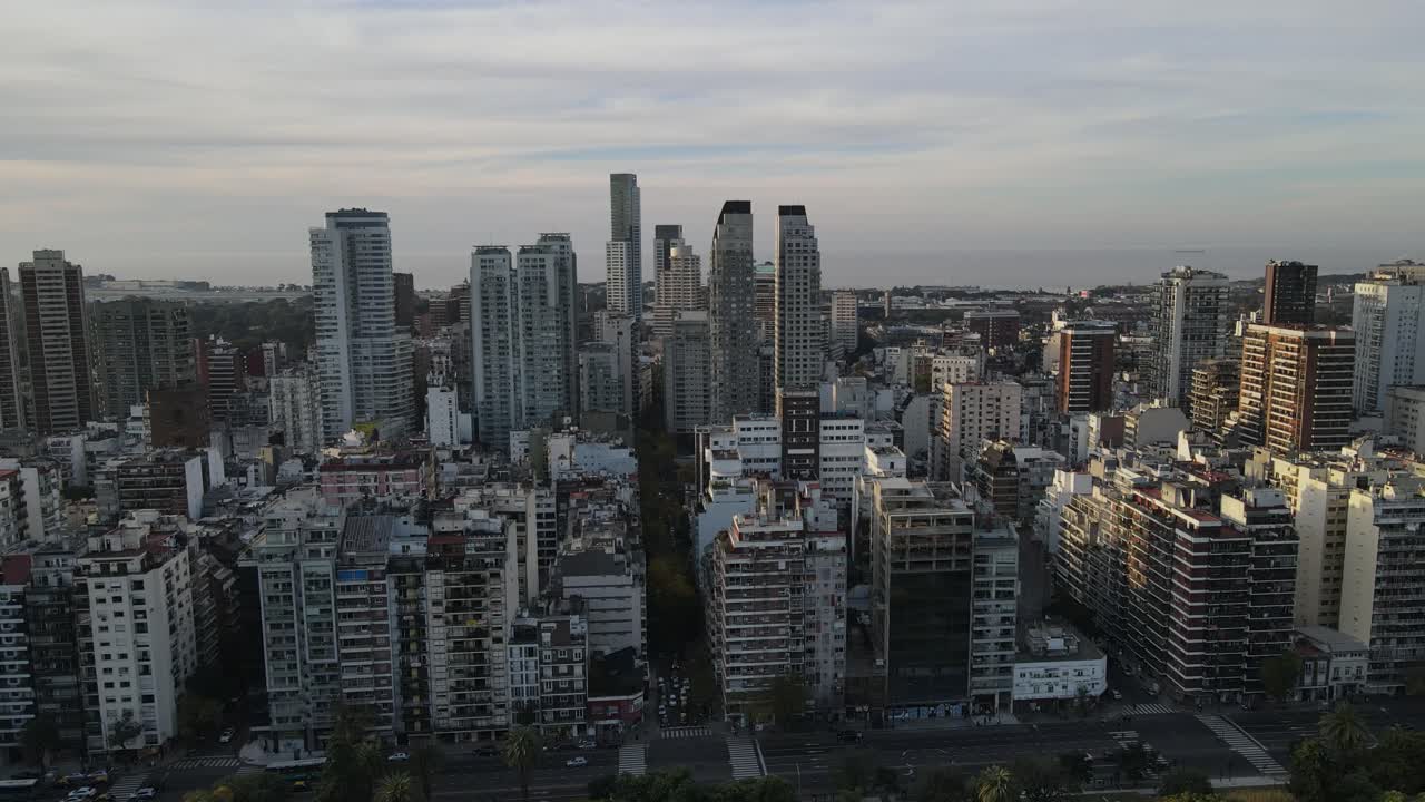 Aerial flight showing skyline with skyscraper buildings in Buenos Aires, Argentina during golden hour.