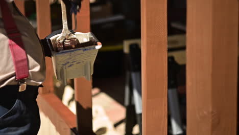 Male-Worker-Paints-Wood-With-Brown-Color-On-Patio-With-Roller