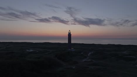 magical sunset at lighthouse westhoofd ouddorp on coastline, aerial