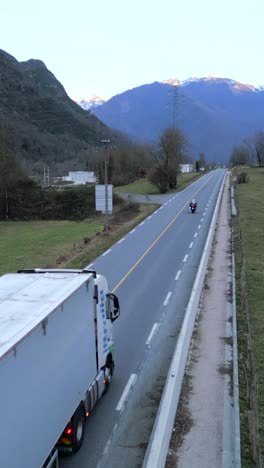 road with cars and trucks in a mountainous landscape