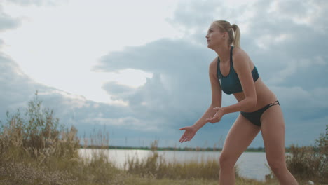 failed-attack-at-beach-volleyball-match-woman-is-blocking-ball-over-net-team-of-female-players-training-and-competing