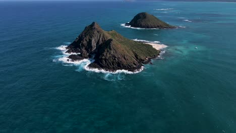 aerial rise up shot of mokulua islands and rugged oahu coast, hawaii