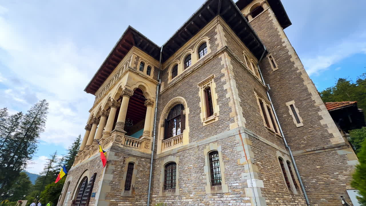 Busteni, Romania, 17 July 2025: Coming up to Cantacuzino Castle on a rainy afternoon. Beautiful historical building from low angle perspective