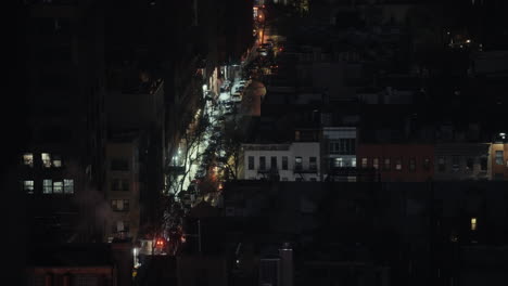 night view of a city street with fire truck