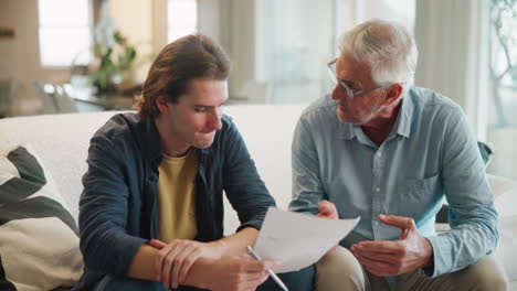 father and son discussing documents at home