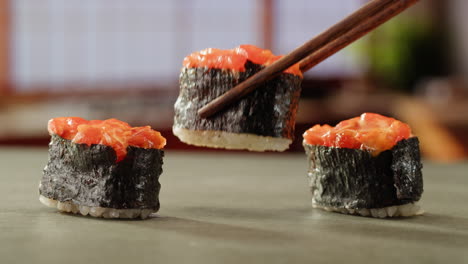 sushi rolls with chopsticks