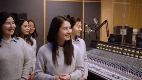 smiling group collaborating in a modern recording studio