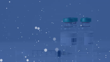 animation of spots of light over vaccine bottles and syringe