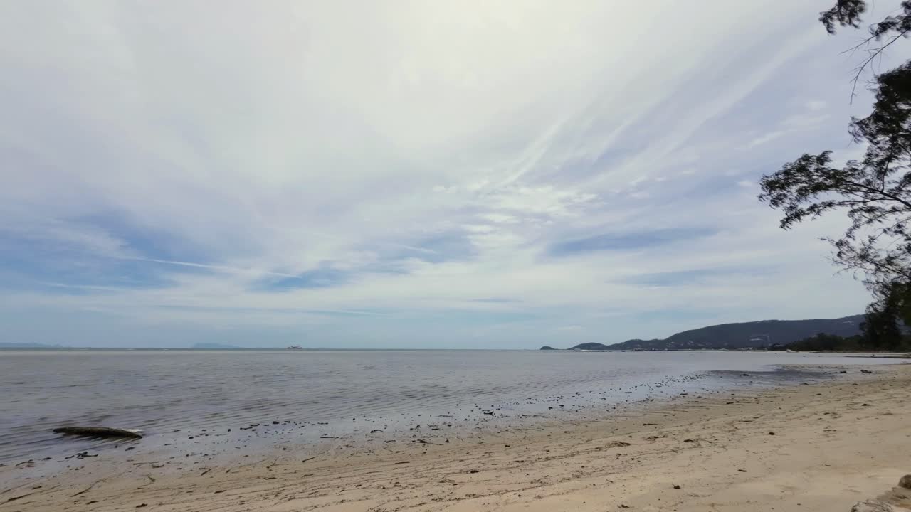 Time-lapse sequence at Lamai Beach, Koh Samui, Thailand, capturing the sandy coastline, turquoise ocean, and fast-moving clouds in a tropical seascape