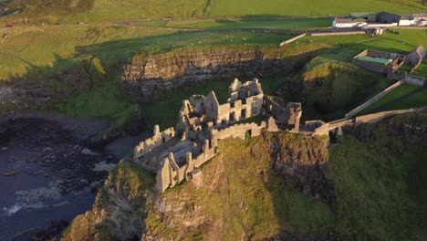 Aerial-view-of-Dunluce-Castle-on-a-sunny-evening,-County-Antrim,-Northern-Ireland