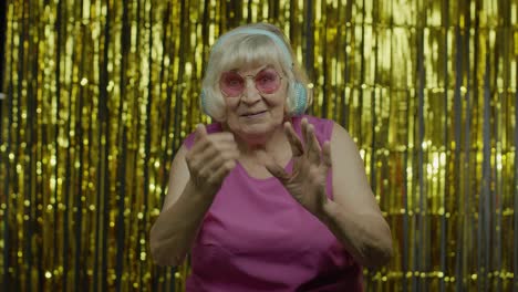 friendly senior old woman waving hands looking at camera with toothy smile, saying hi, greeting