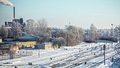 Toma-De-Lapso-De-Tiempo-Del-Tren-Industrial-Que-Conduce-Al-Edificio-De-La-Fábrica-Durante-El-Día-De-Invierno-Cubierto-De-Nieve