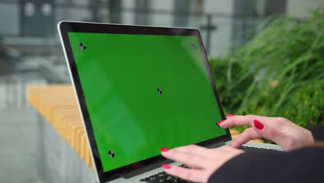 new technology concept. young woman with red nails typing on the keyboard