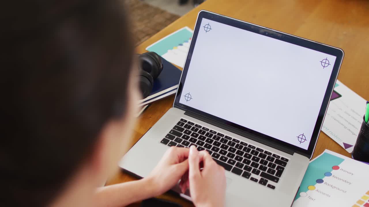 Caucasian woman sitting at desk, having laptop video call with copy space