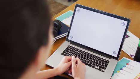 caucasian woman sitting at desk, having laptop video call with copy space