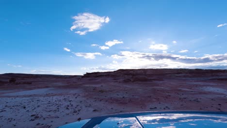 driver gets out of his truck to scout a desert camping site