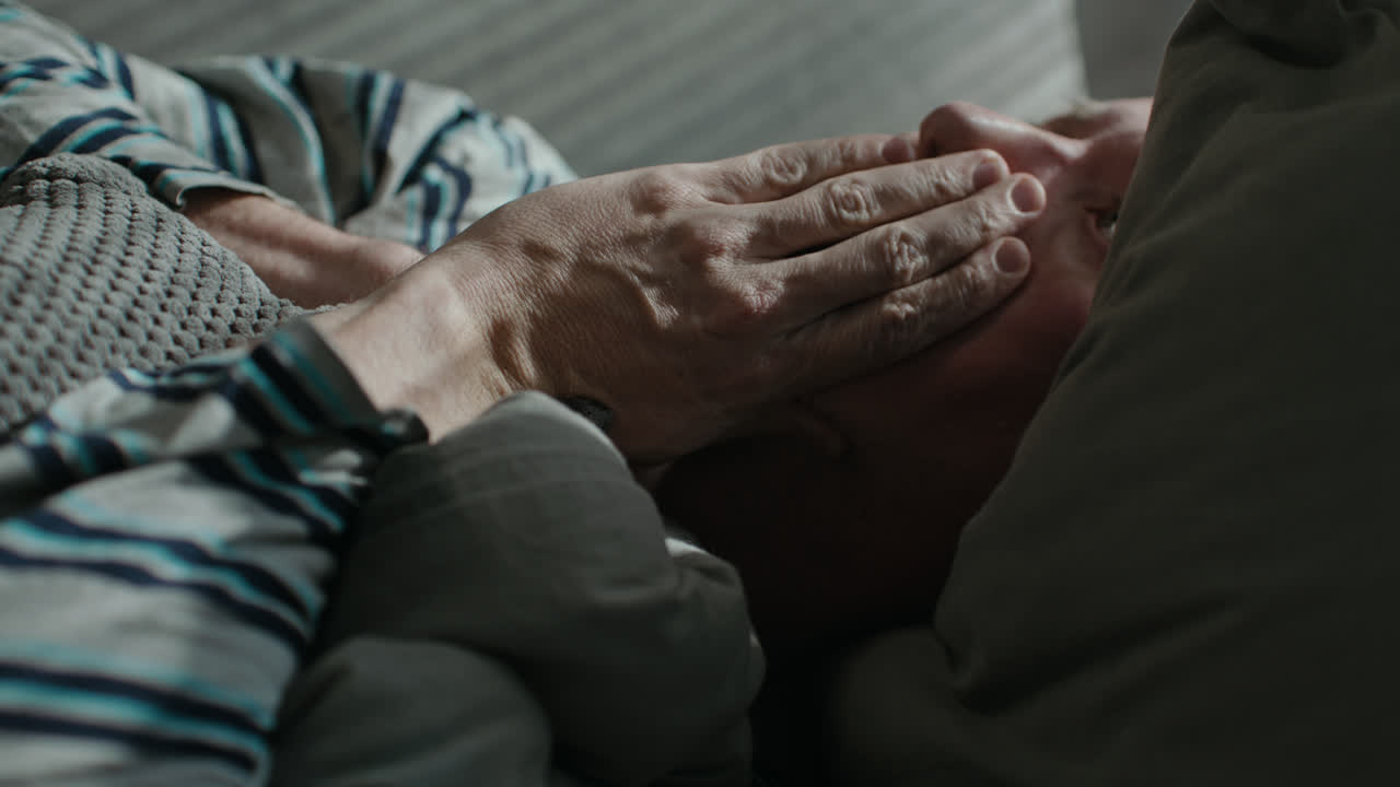 A sad man wakes up tired on his sofa