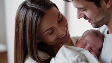 loving parents cradling their newborn baby