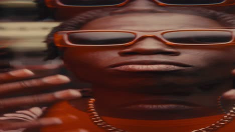 confident black man in sunglasses dancing to hip-hop music on camera