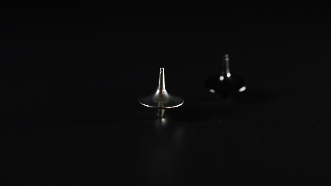 어두운 표면에서 회전하는 다양한 꼭대기