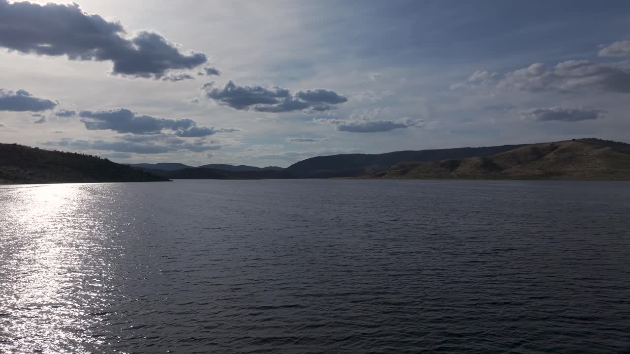 Lake view with mountains and cloudy sky