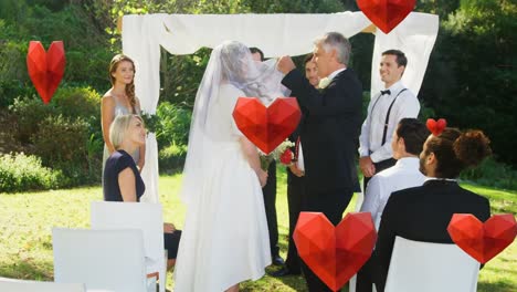 Animation-of-hearts-falling-over-caucasian-couple-during-wedding-ceremony