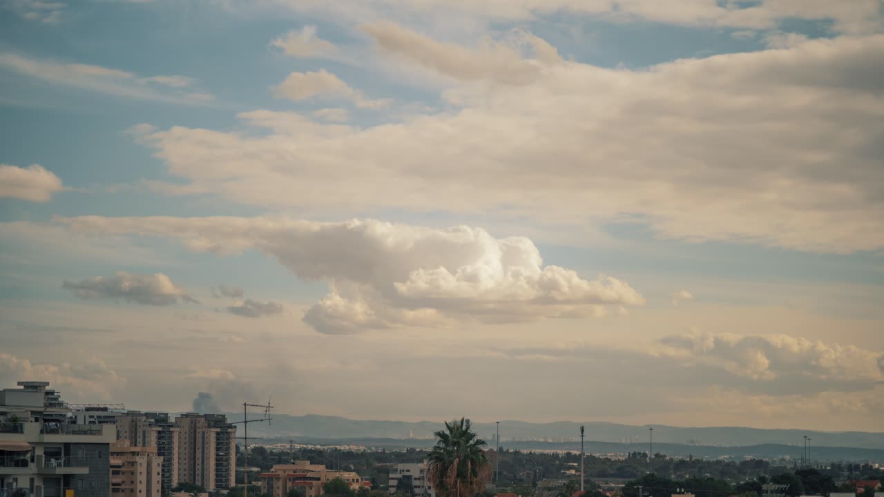 A real time lapse of a sunset over the city, was shot from the roof, Israel Tel Aviv, middle east, colorful surfing clouds, golden hour, cityscape, Sony 4K video