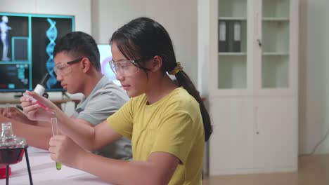young asian boy and girl learning science experiment in laboratory at classroom. study with scientific equipment and test tubes