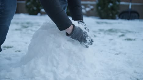 grandfather and granddaughter having fun in the snow