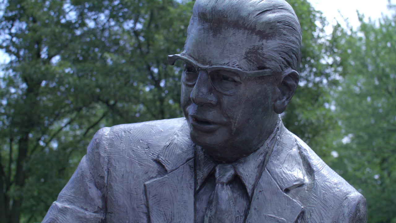 Bronze Statue of a Man in a Suit Holding a Cigar