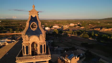 aerial view of a spanish town with a historical church and bell tower at sunset