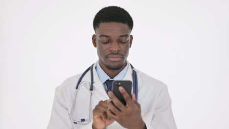 african doctor browsing smartphone on white background