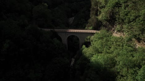 aerial forward view of a bridge into a mountain gorge: southern italy