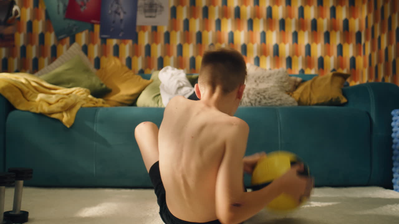 Boy doing sit-ups at home