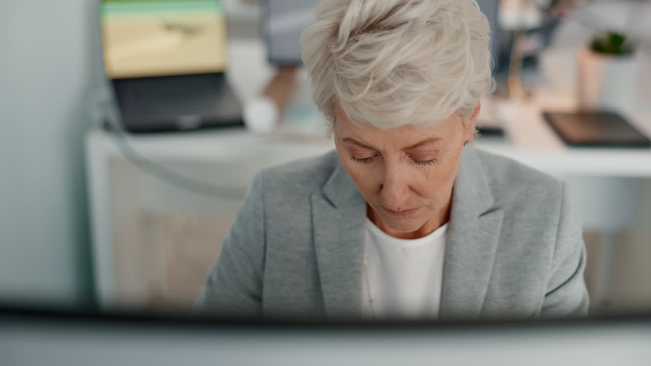 Mature woman, thinking or computer in office