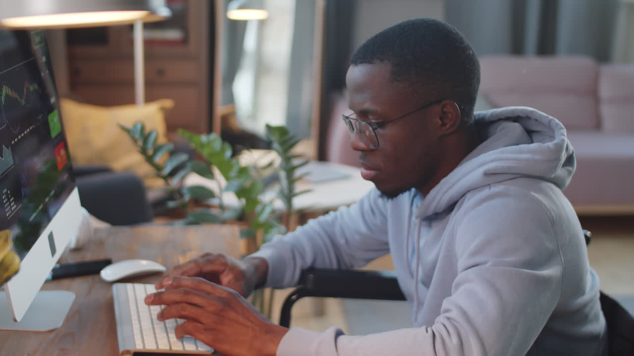 Man in Wheelchair Working on Computer